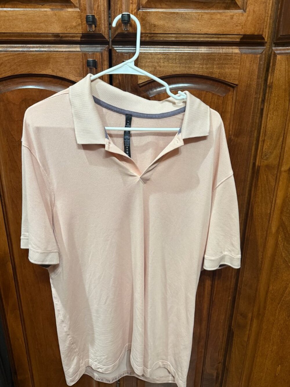 lululemon men’s short sleeve polo in a soft blush/light pink color
